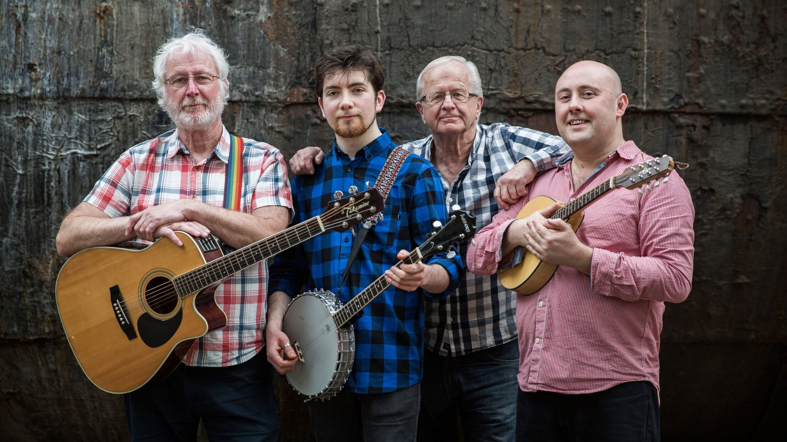 The four bandmates pose with their instruments.