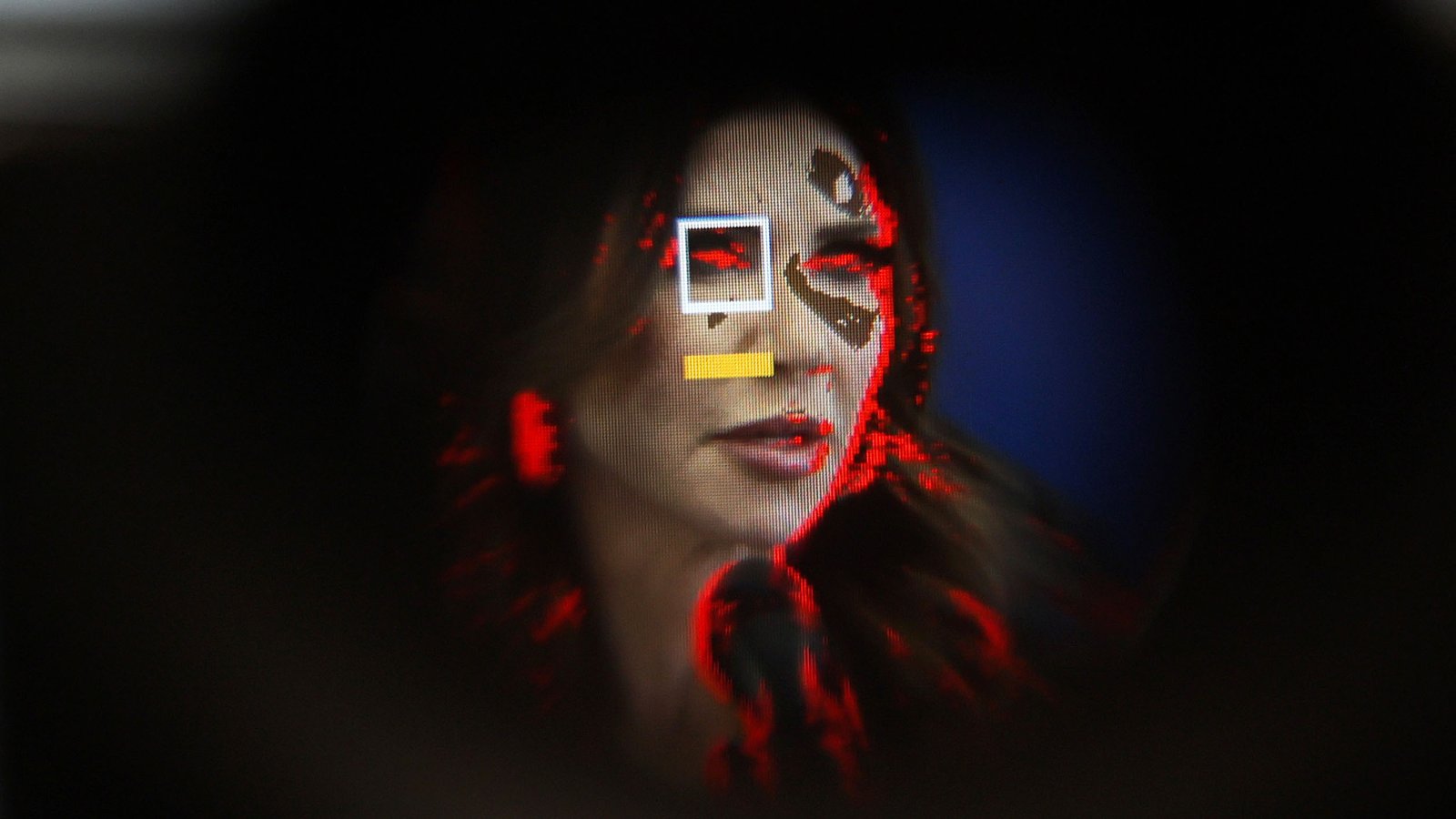 Kristi Noem seen pixelated through the viewfinder of a camera