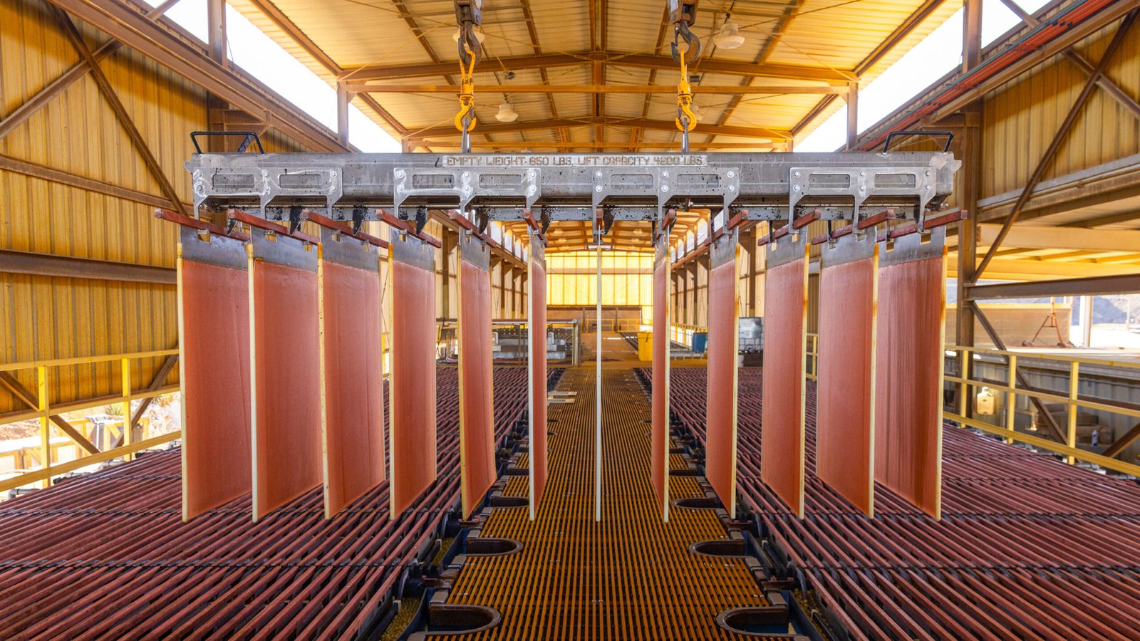 sheets of metal hang in a warehouse